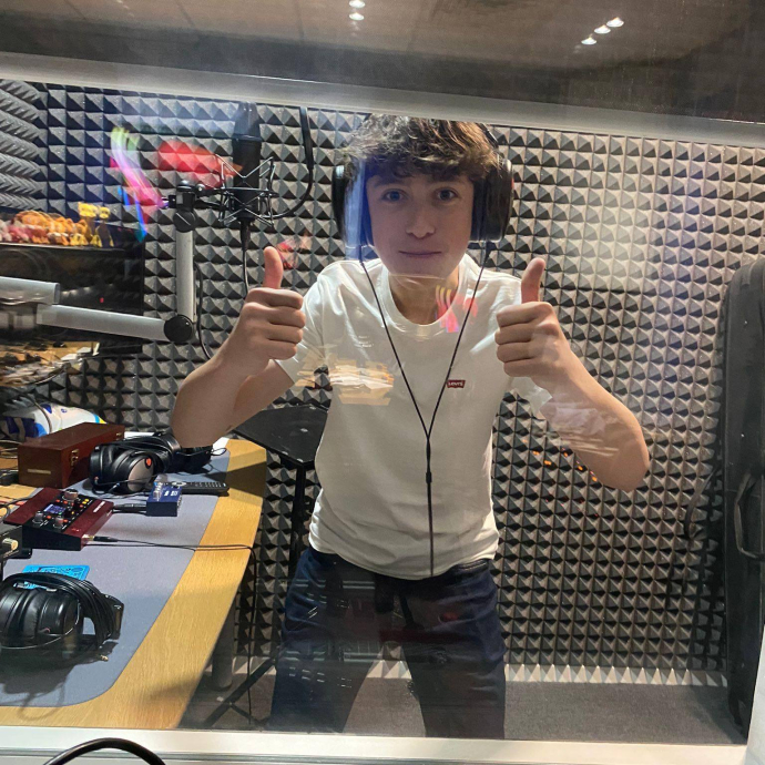 Person in Yr Egin's soundbooth giving a double-thumbs-up